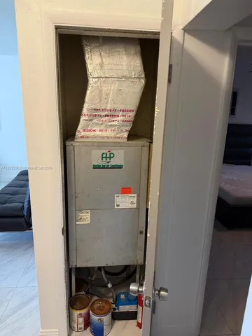 a room with a wooden floor and cabinets