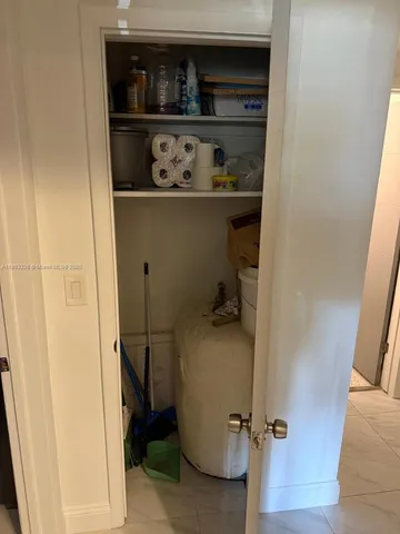 a white toilet sitting next to a shower curtain