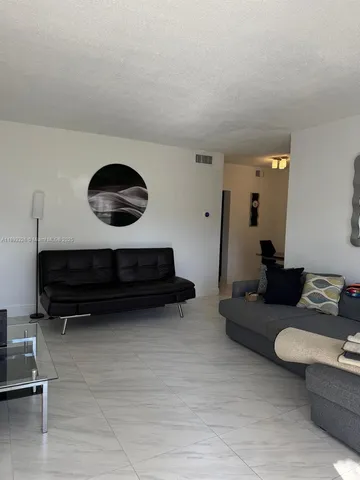 a living room with furniture and a mirror