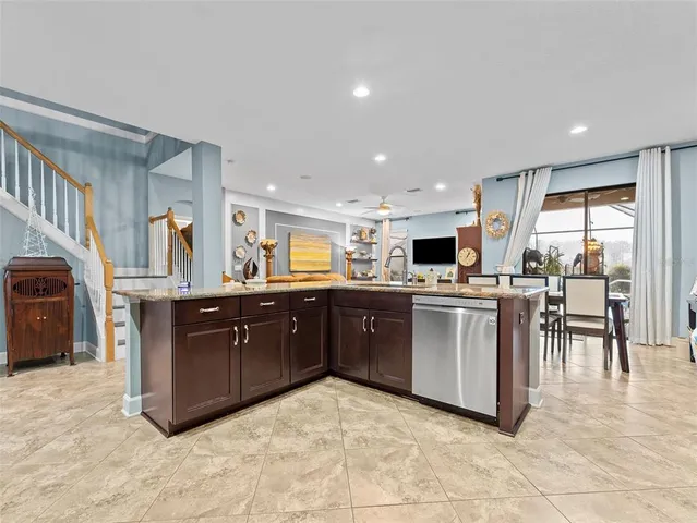 a kitchen with stainless steel appliances granite countertop a refrigerator and cabinets