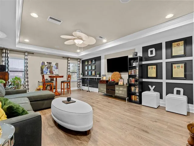 a bedroom with a bed and a flat tv screen on the dresser