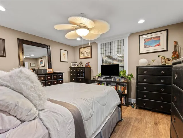 a spacious bedroom with a bed and a chandelier