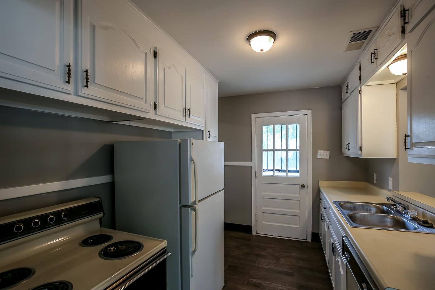 746 Waring Road Memphis, TN 38122 - Photo 3 of 16 Kitchen with range, white cabinets, sink, dishwasher, and dark wood-type flooring