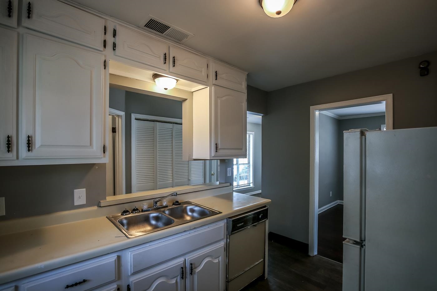 746 Waring Road Memphis, TN 38122 - Photo 4 of 16 Kitchen with sink, white cabinetry, dark hardwood / wood-style flooring, and white appliances
