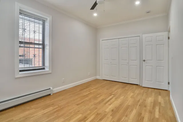 a view of an empty room with wooden floor
