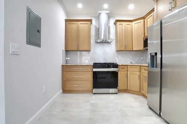 a kitchen with stainless steel appliances a stove and a refrigerator
