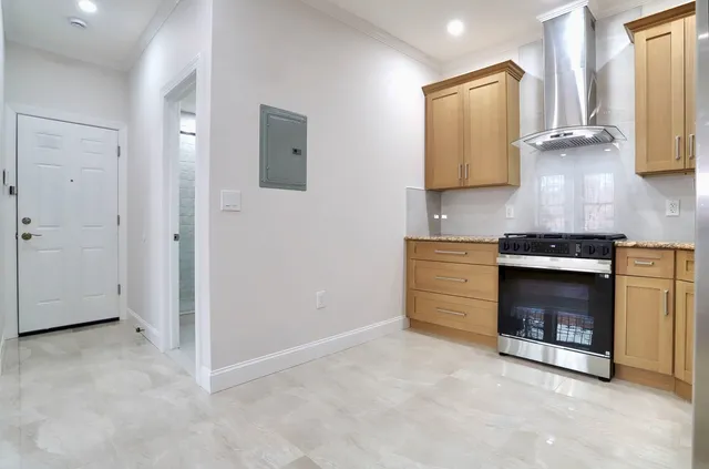 a kitchen with granite countertop cabinets stainless steel appliances and a sink