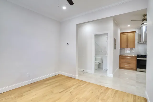 a view of empty room with wooden floor