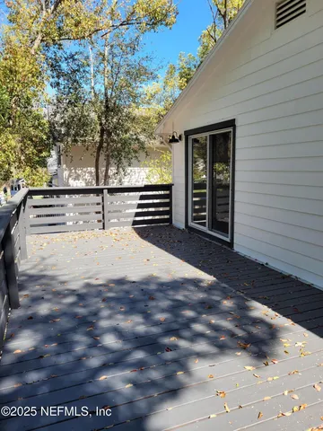 a view of a house with a tree in front