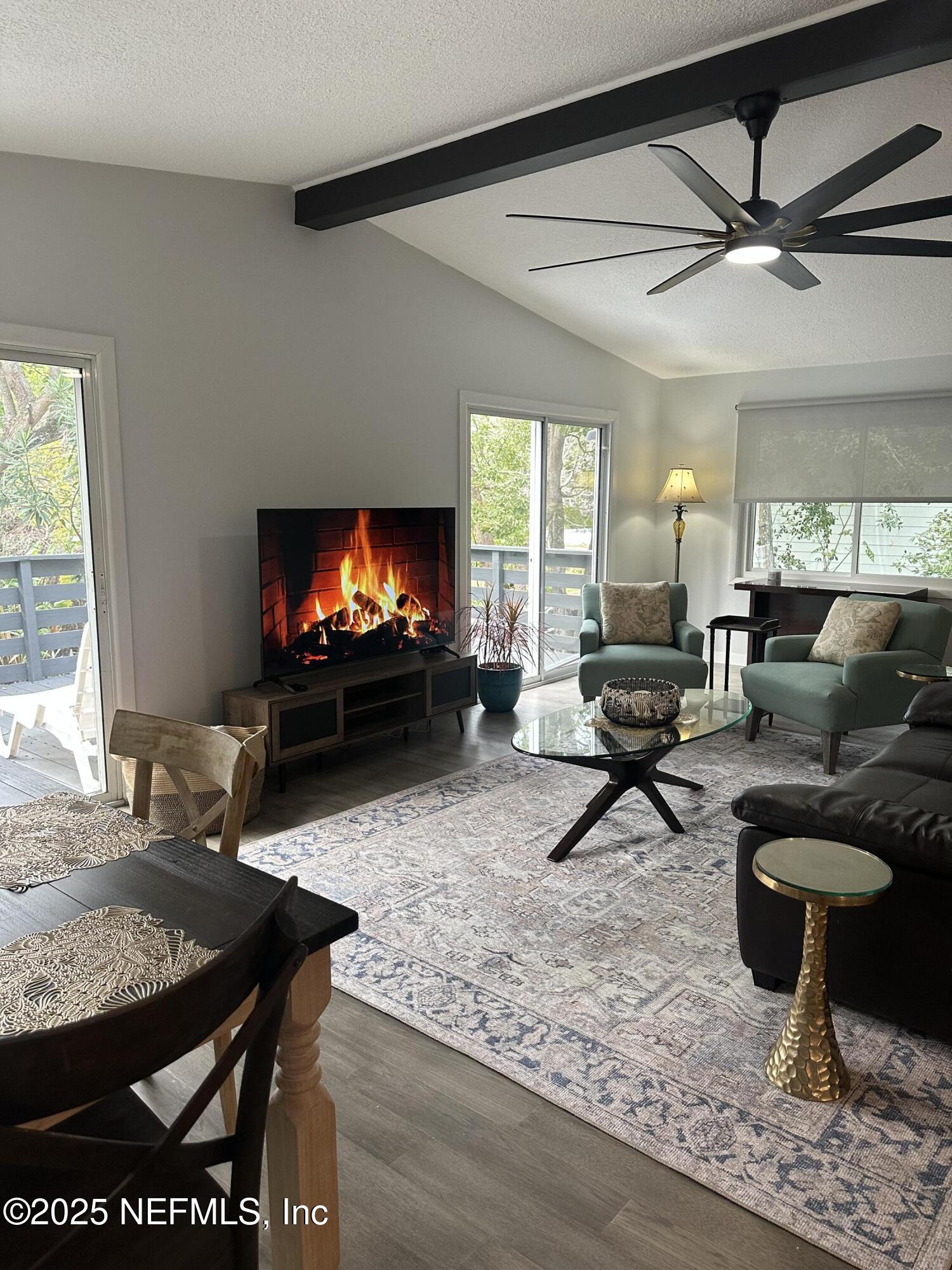 514 South 4th Street, Unit A Fernandina Beach, FL 32034 - Photo 2 of 13 a living room with furniture and a flat screen tv