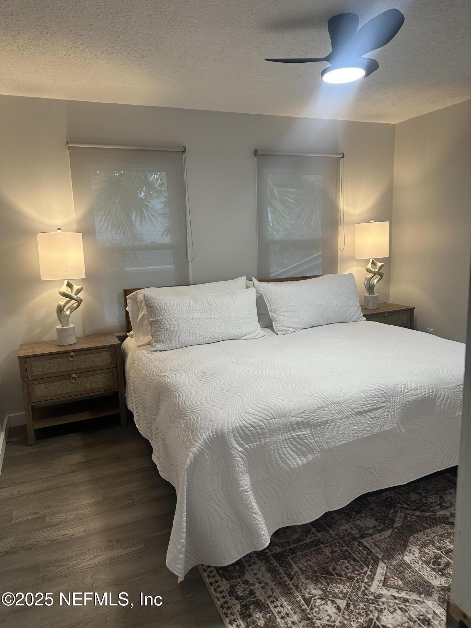 514 South 4th Street, Unit A Fernandina Beach, FL 32034 - Photo 7 of 13 a bedroom with a bed and a night stand