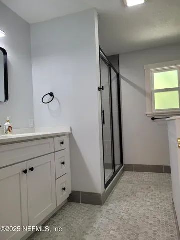 a bedroom with a bed and a chandelier fan