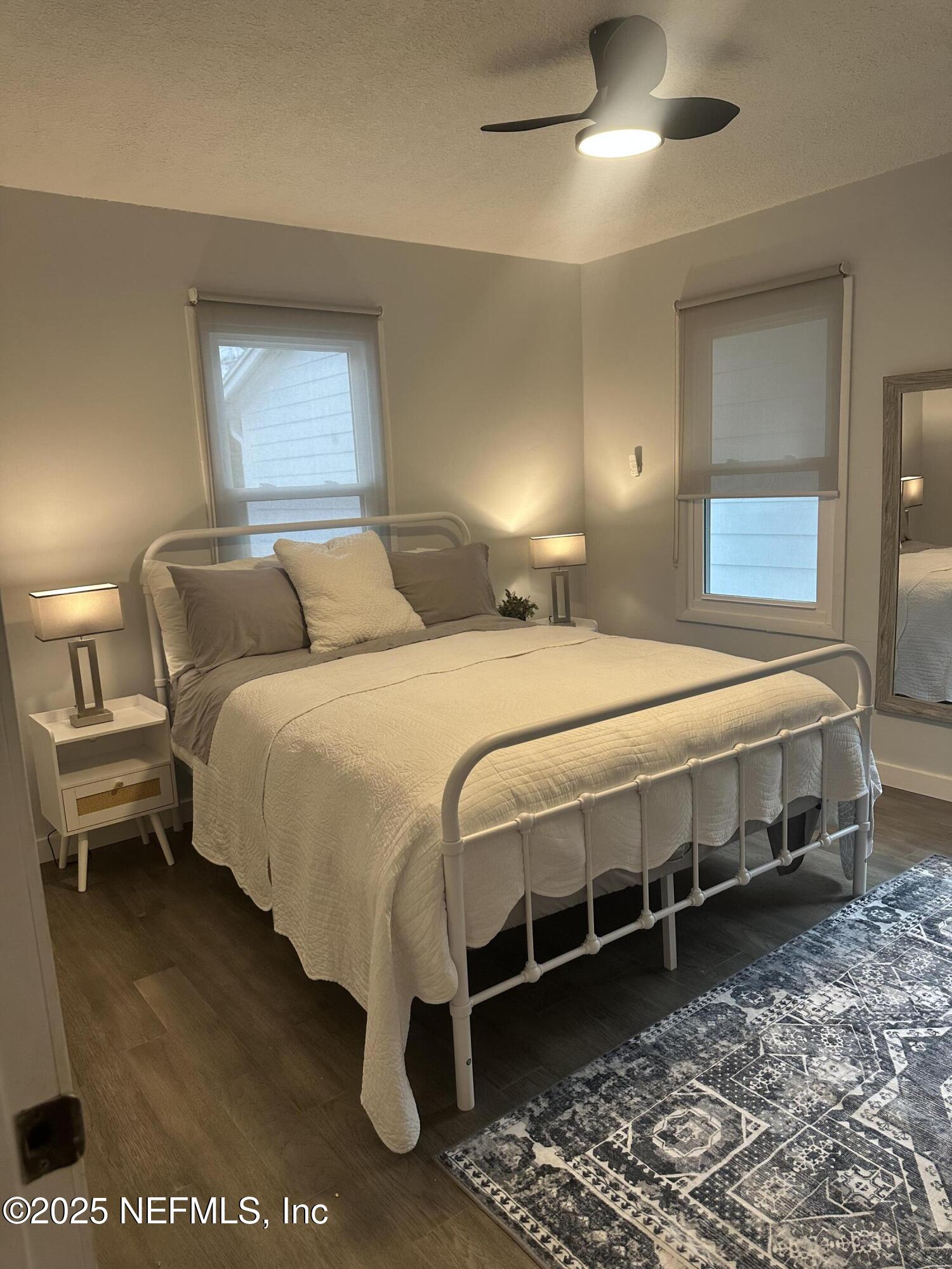 514 South 4th Street, Unit A Fernandina Beach, FL 32034 - Photo 10 of 13 a bedroom with a bed and a chandelier fan