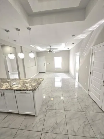 a view of a kitchen with kitchen island white appliances