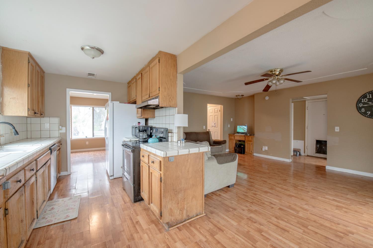 14531 West Kearney Boulevard Kerman, CA 93630 - Photo 15 of 22 a kitchen with sink stove and cabinets
