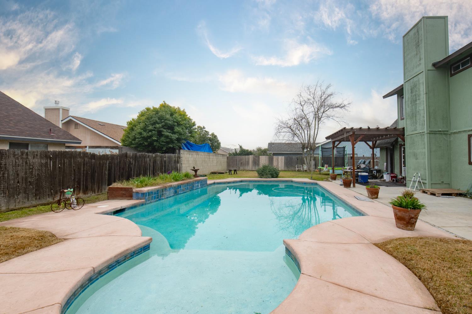 14531 West Kearney Boulevard Kerman, CA 93630 - Photo 2 of 22 a view of a swimming pool with a patio