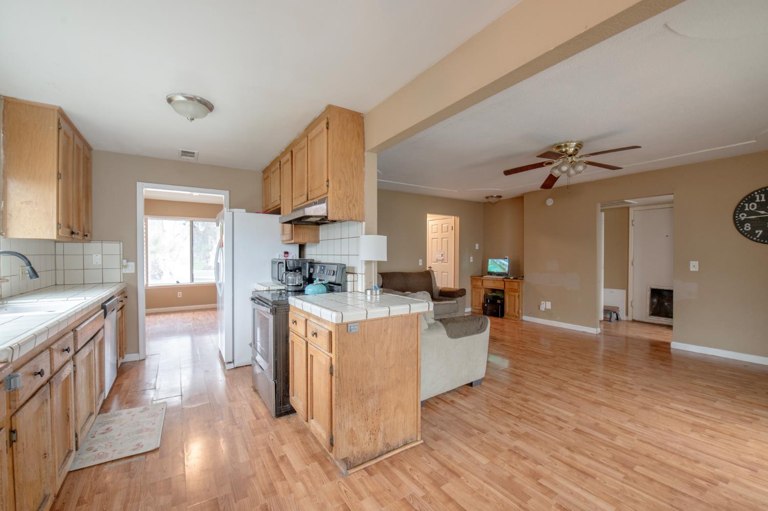 14531 West Kearney Boulevard Kerman, CA 93630 - Photo 6 of 22 a kitchen with sink stove and cabinets