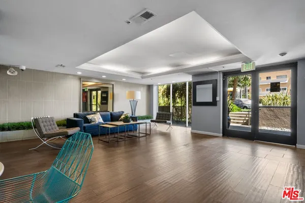 a living room with fireplace furniture and a wooden floor