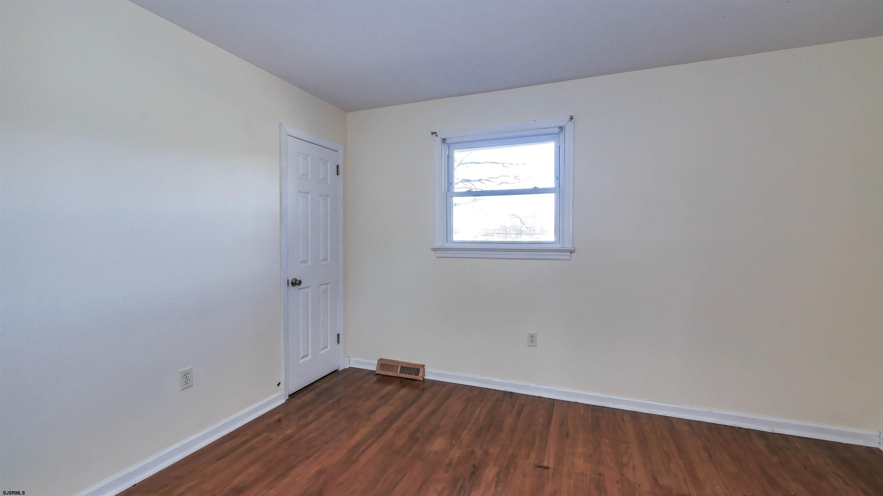 145 Webb Road Absecon, NJ 08201 - Photo 26 of 38 an empty room with wooden floor and windows