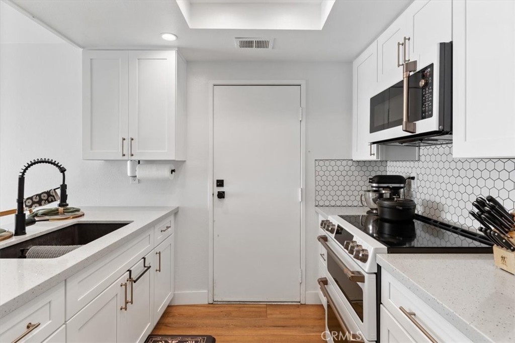 16873 Donwest Tustin, CA 92780 - Photo 14 of 42 a kitchen with stainless steel appliances a sink a stove and cabinets