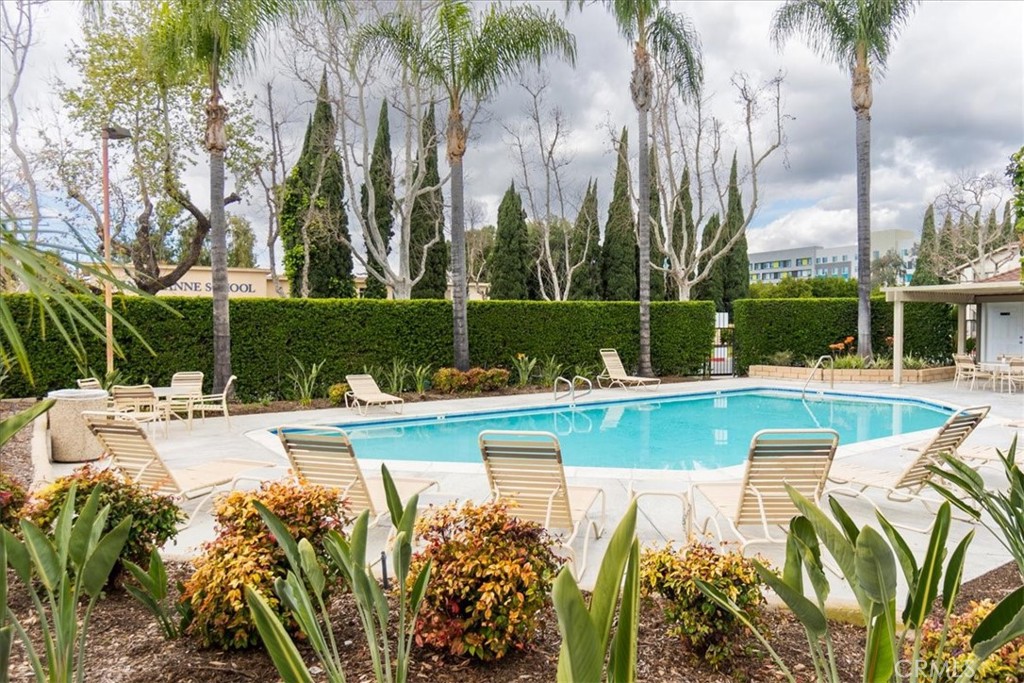 16873 Donwest Tustin, CA 92780 - Photo 39 of 42 a view of a swimming pool with a lawn chairs under palm trees