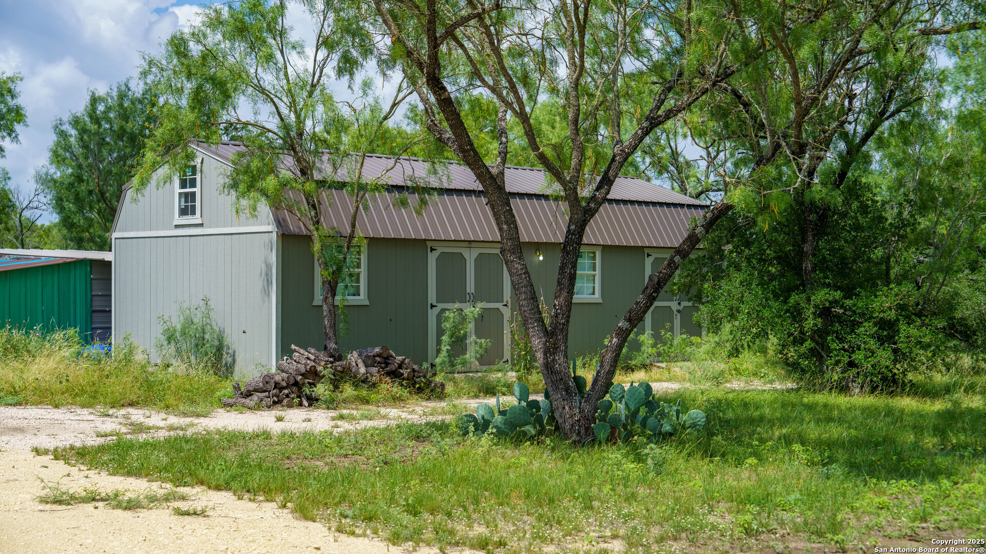 1231 B & R Road Vanderpool, TX 78885 - Photo 5 of 26 a view of a house with a yard and plants