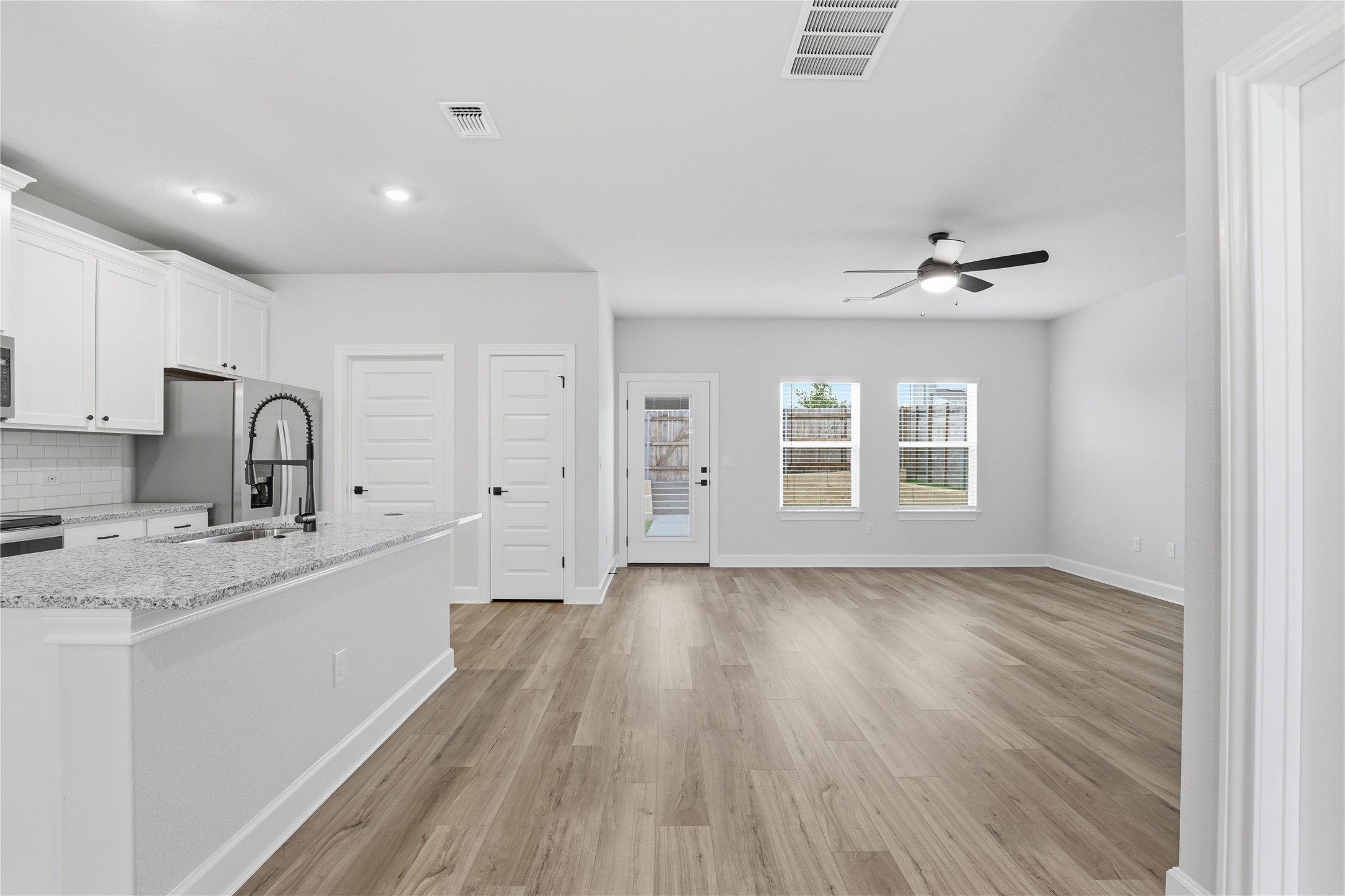 9320 Gladsome Path Manor, TX 78653 - Photo 13 of 34 a view of a kitchen with sink hardwood floor and a window