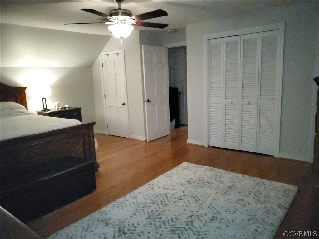 12901 Silver Crest Road Chester, VA 23831 - Photo 17 of 42 a bedroom with a bed and a chandelier
