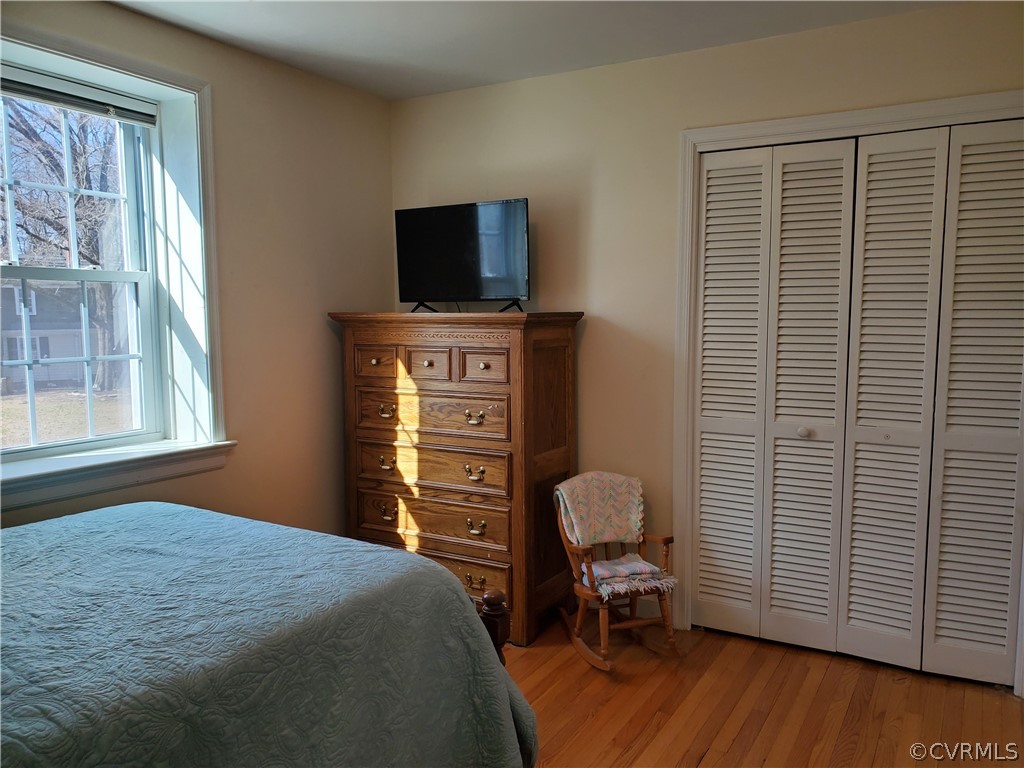 12901 Silver Crest Road Chester, VA 23831 - Photo 25 of 42 a bedroom with a bed and wooden floor