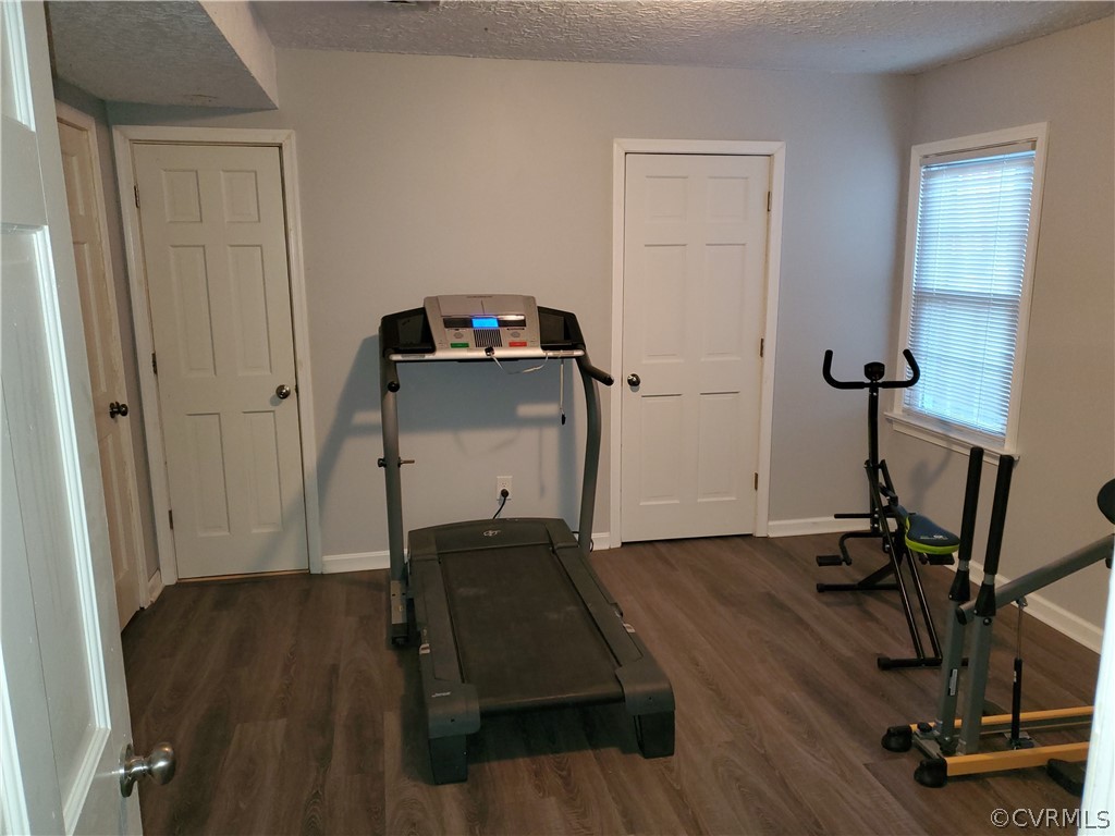 12901 Silver Crest Road Chester, VA 23831 - Photo 30 of 42 a room with wooden floor and gym equipment