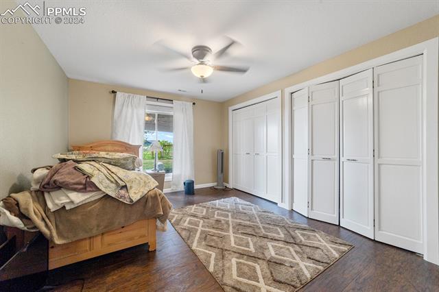 3240 Spaatz Road Monument, CO 80132 - Photo 32 of 45 Bedroom #4 with multiple closets, ceiling fan, and dark hardwood / wood-style floors
