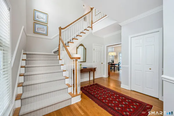 a view of entryway and hall with wooden floor