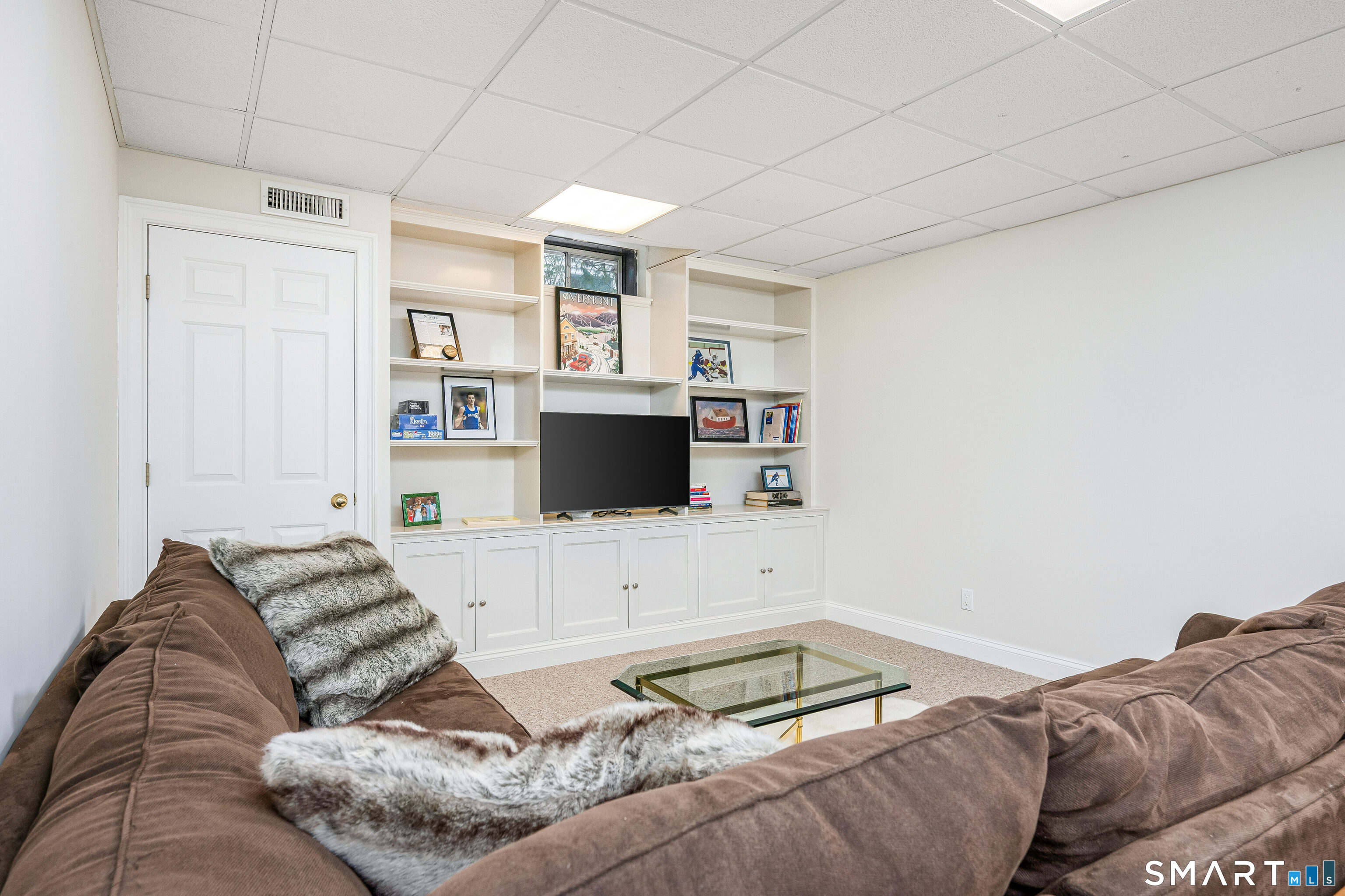 43 Phillips Lane Darien, CT 06820 - Photo 19 of 29 a bedroom with a bed and a flat screen tv