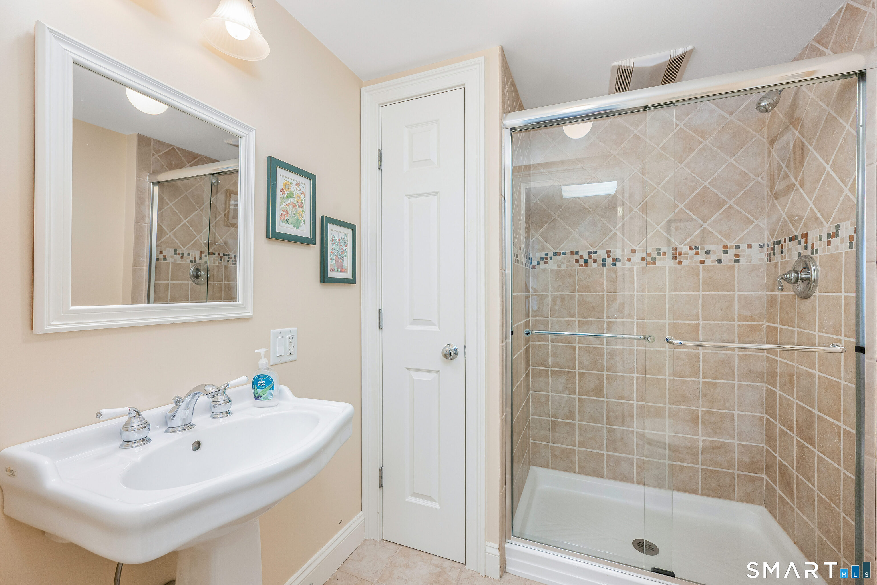 43 Phillips Lane Darien, CT 06820 - Photo 21 of 29 a bathroom with a shower a mirror and a sink