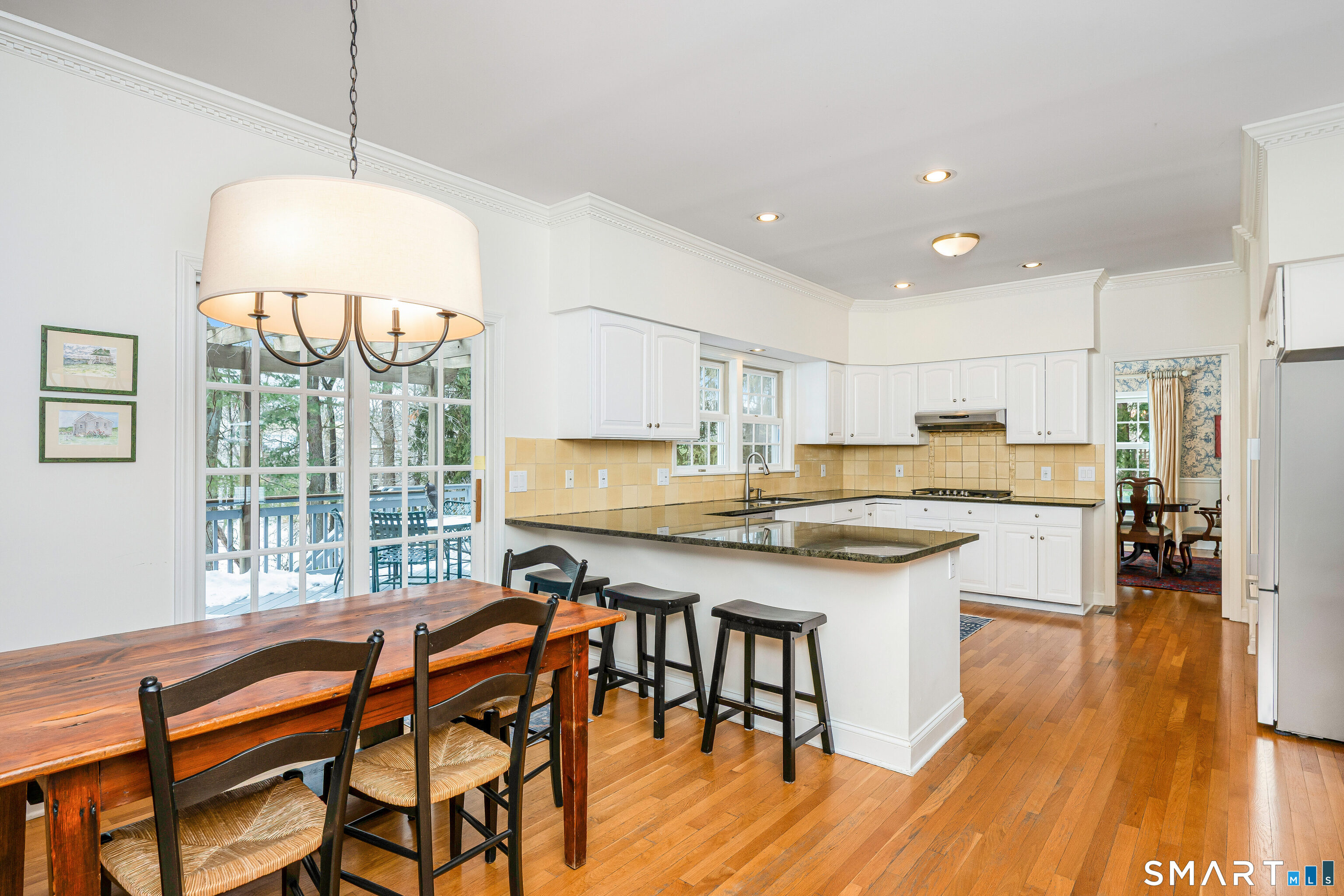 43 Phillips Lane Darien, CT 06820 - Photo 6 of 29 a kitchen with a table chairs sink and cabinets