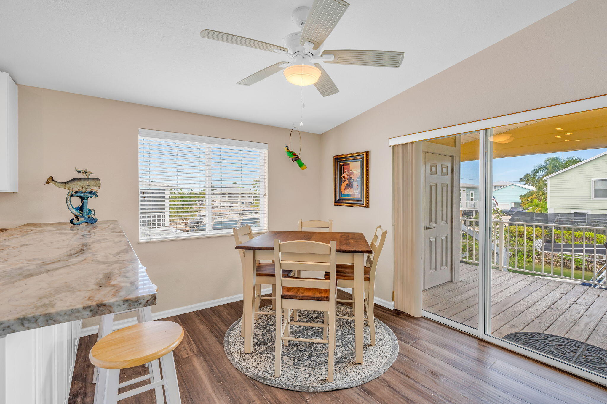 28571 Buccaneer Road Summerland Key, FL 33042 - Photo 11 of 40 a view of a dining room with furniture wooden floor and chandelier