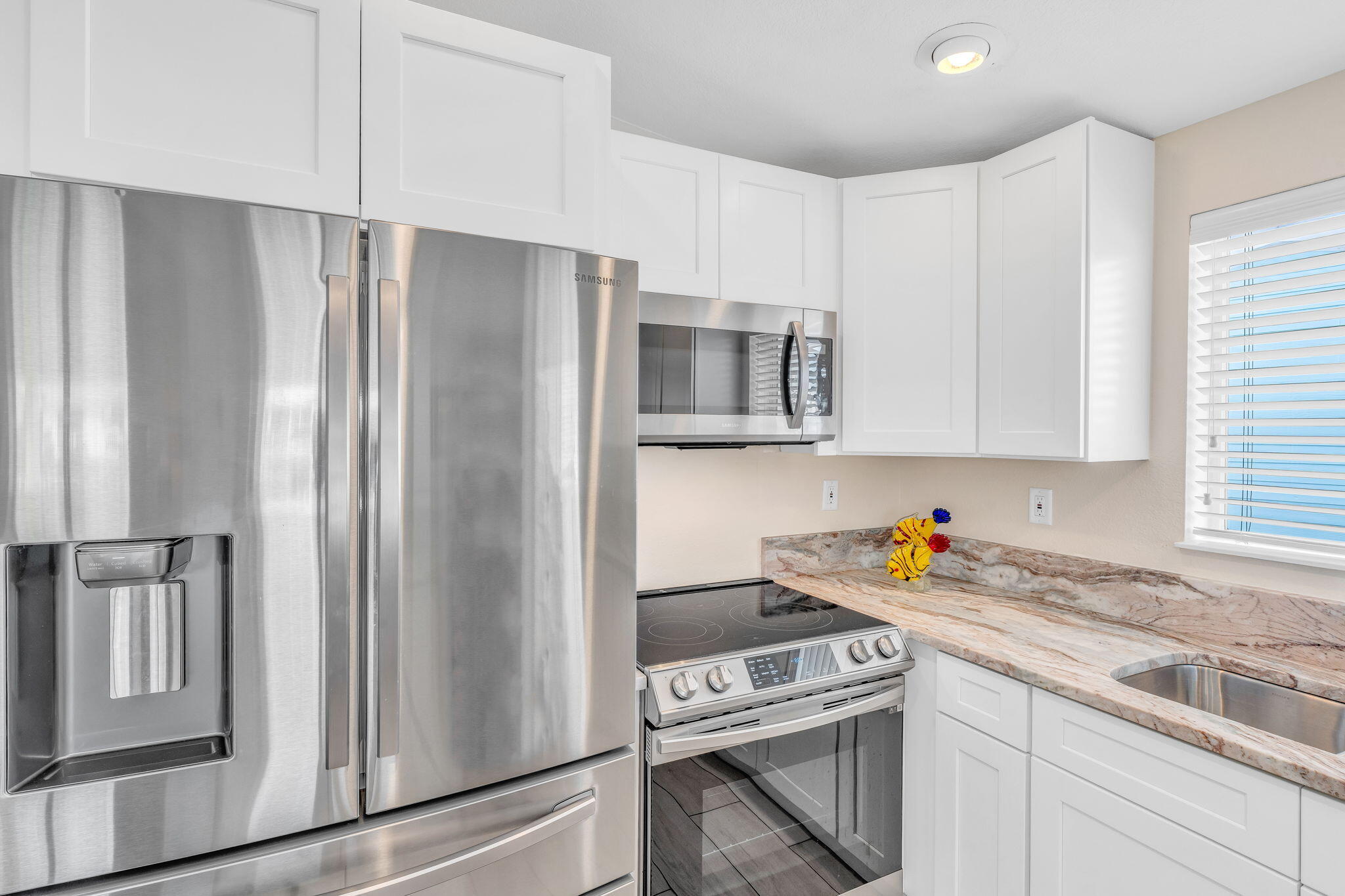 28571 Buccaneer Road Summerland Key, FL 33042 - Photo 14 of 40 a kitchen with stainless steel appliances a refrigerator sink and microwave