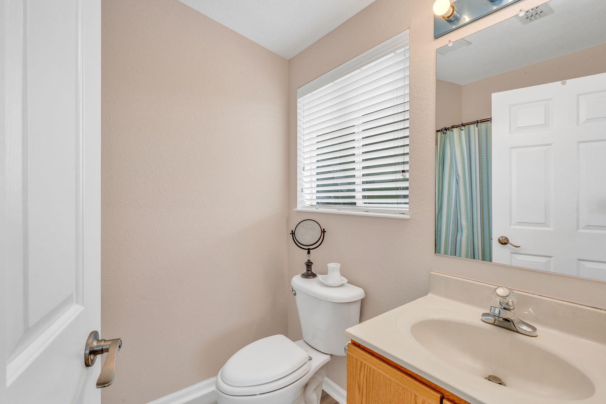 28571 Buccaneer Road Summerland Key, FL 33042 - Photo 22 of 40 a bathroom with a sink a toilet and mirror