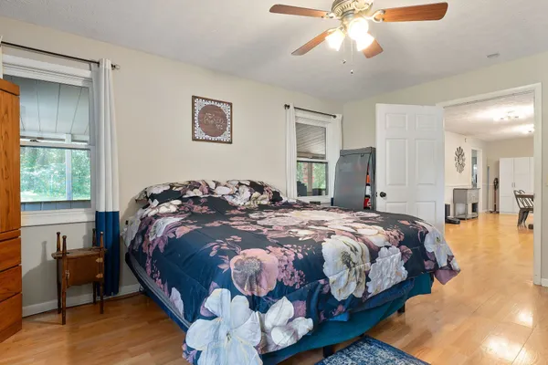 a bed sitting in a bedroom next to a window