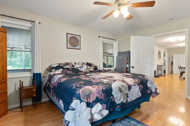 a bed sitting in a bedroom next to a window