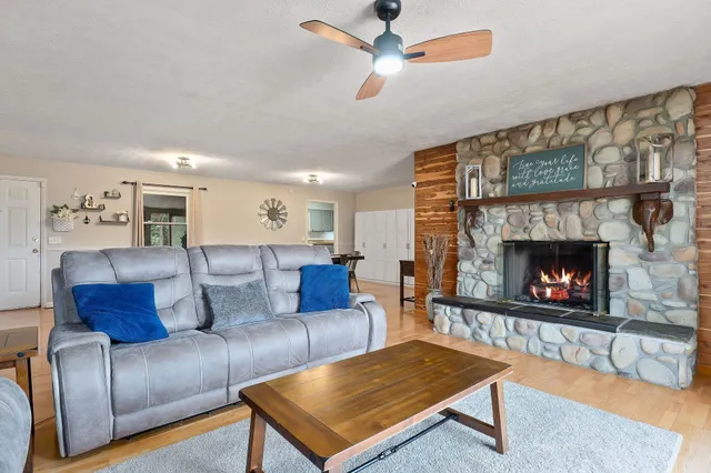 a fireplace with a clock on wall