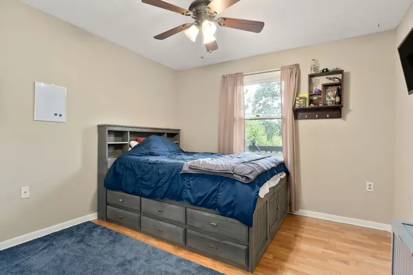 a bedroom with a bed and a window