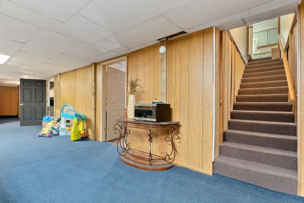 a view of a swimming pool with a yard and outdoor seating