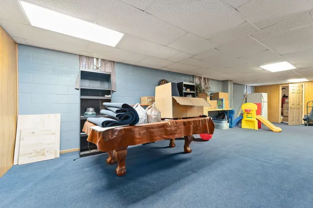 a aerial view of a house with swimming pool and large trees