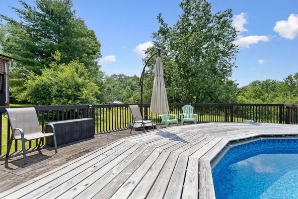 an aerial view of residential houses with outdoor space and lake view
