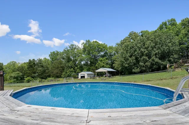 an aerial view of residential houses with outdoor space and swimming pool