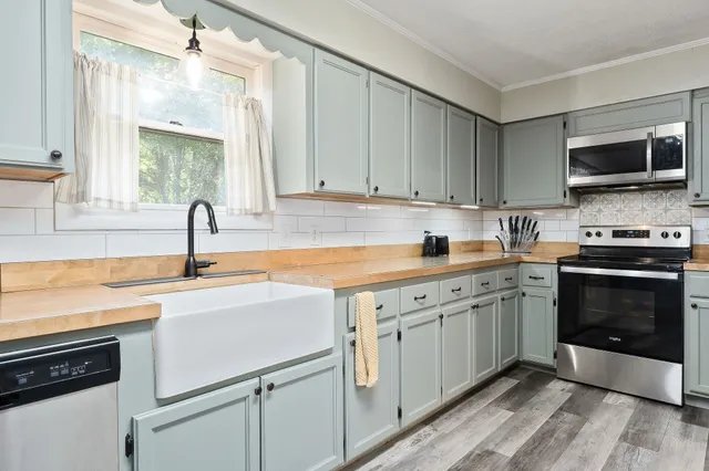 a kitchen with a sink stove and microwave