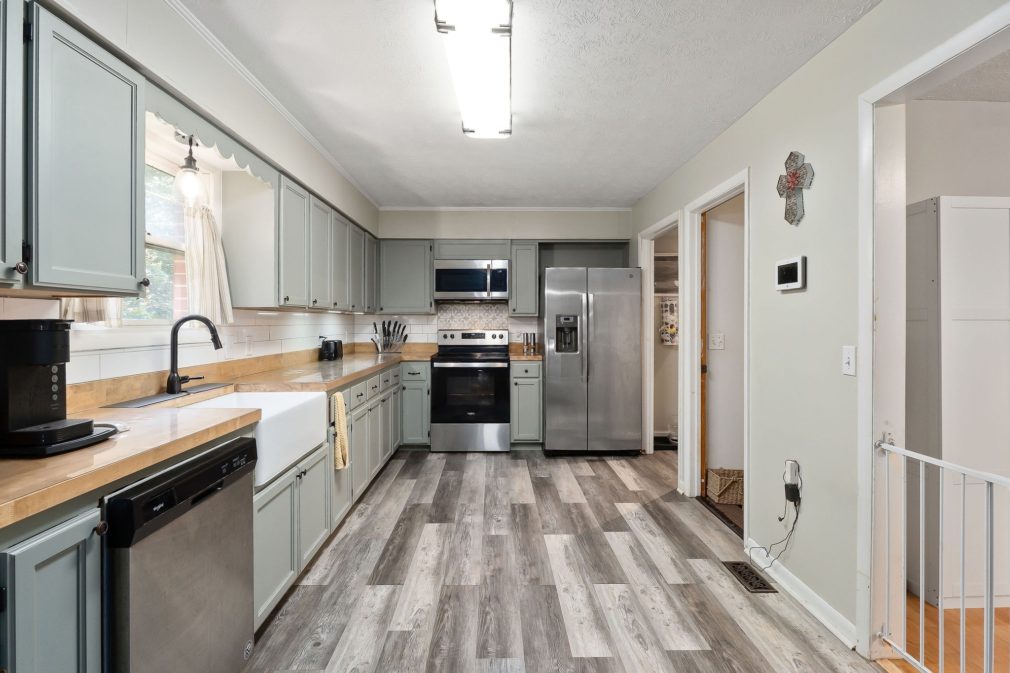 618 Cash Dollar Road Walling, TN 38587 - Photo 8 of 60 a large kitchen with a stove top oven a sink dishwasher a refrigerator and cabinets with wooden floor