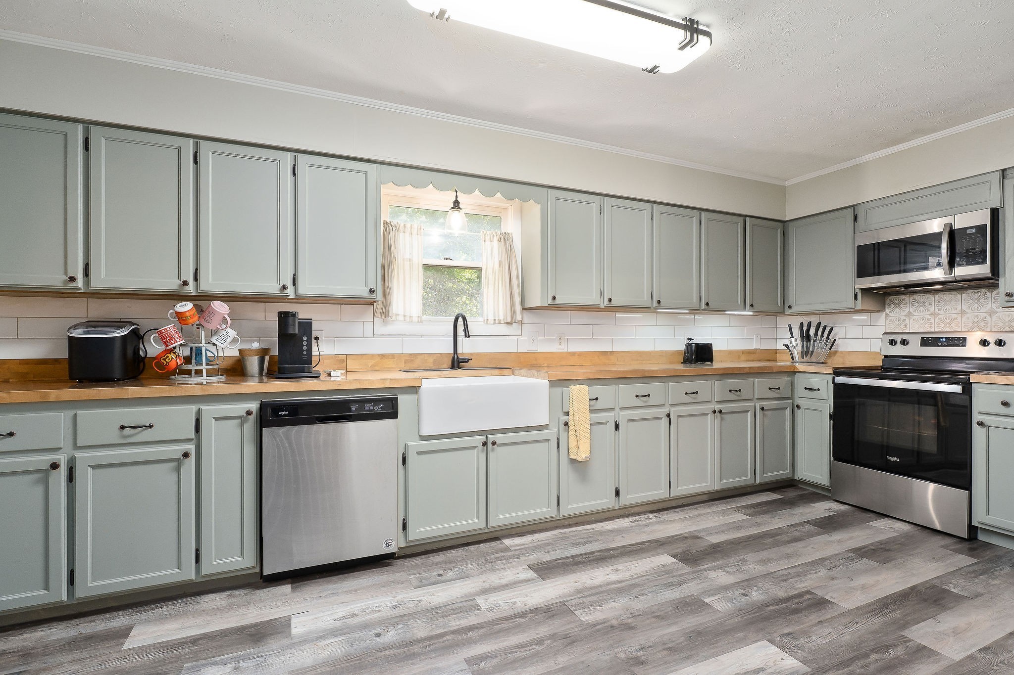 618 Cash Dollar Road Walling, TN 38587 - Photo 9 of 60 a kitchen with granite countertop a sink cabinets and stainless steel appliances