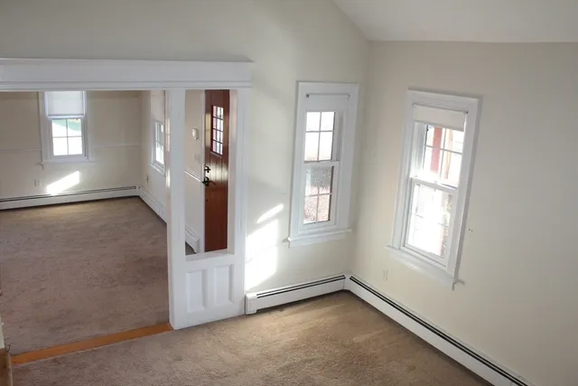 an empty room with windows and closet